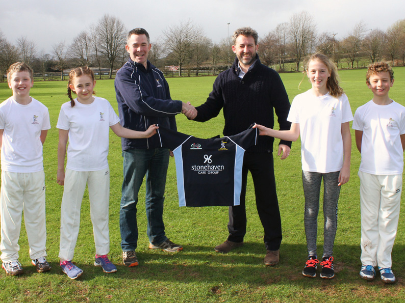 Nathan Stone presenting a new T20 junior shirt to Ipplepenâ€™s junior chairman Andrew Maynard, supported by junior members (left to right) Max Stone, Zoe Maynard, Maggie Winslow and Edward Winslow