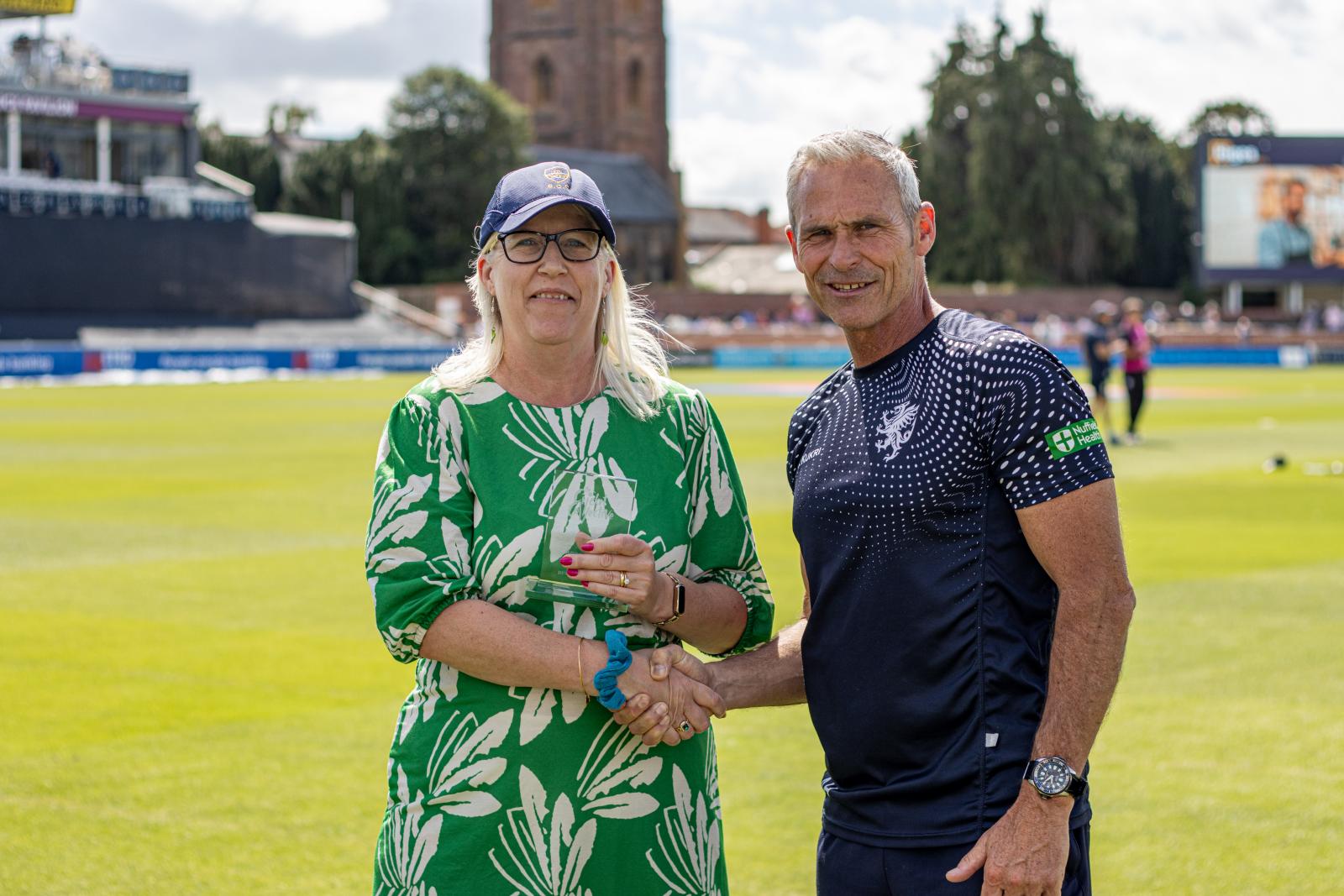 Anne Stone receives her award at the Cooper Associates County Ground.